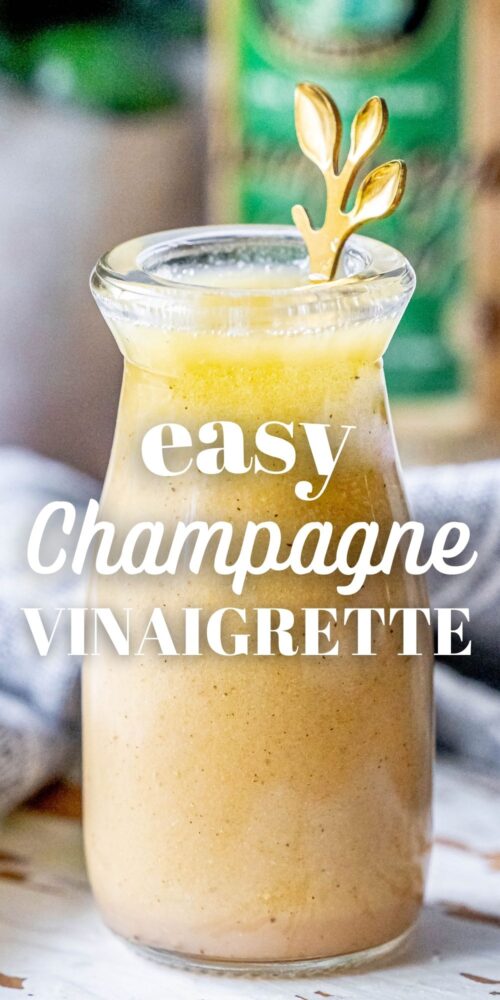 picture of champagne vinaigrette in a bottle with a gold spoon in it