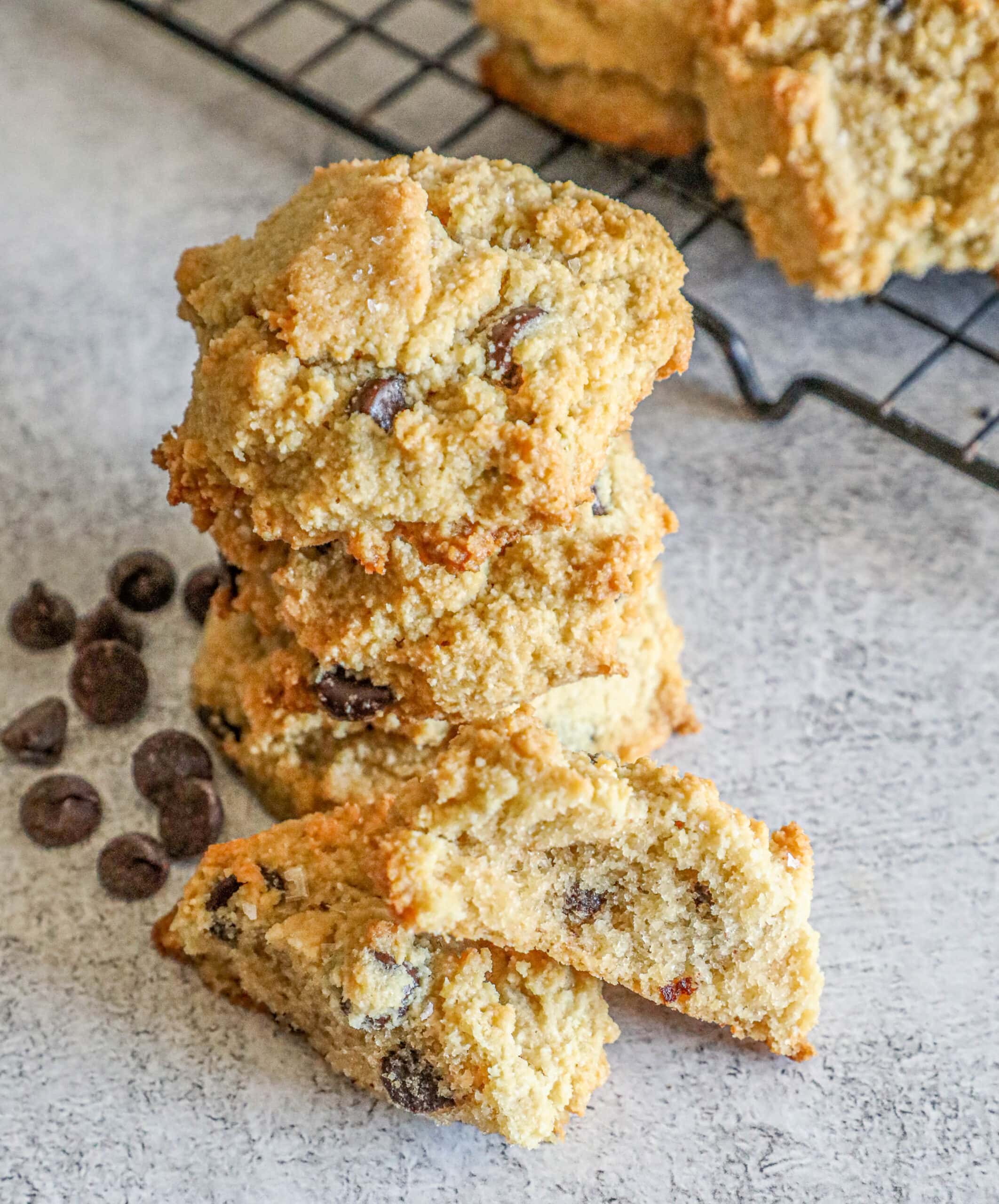 A stack of low carb almond flour chocolate chip cookies on a cooling rack.