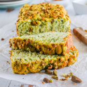 picture of pistachio zucchini bread sliced on parchment paper