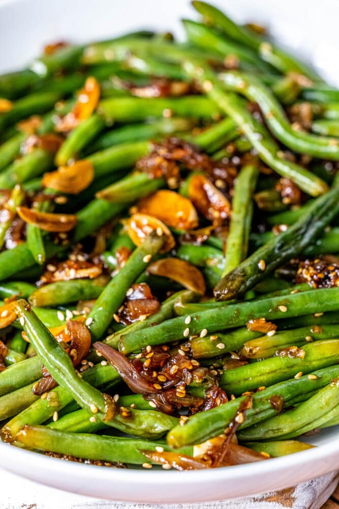 picture of chinese garlic green beans in a white bowl on a table