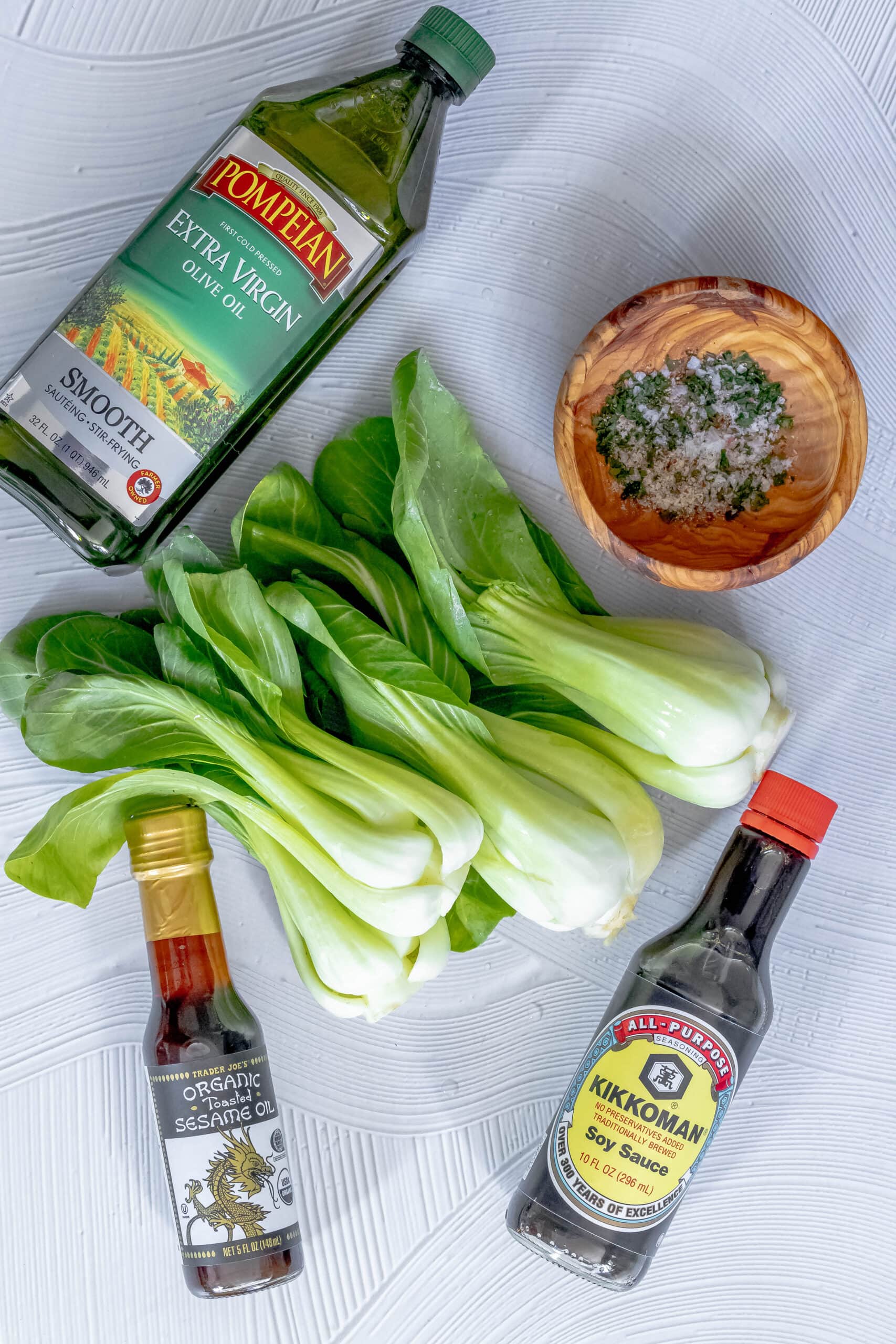 picture of olive oil, bok choy, ginger, sesame oil, and soy sauce on a table