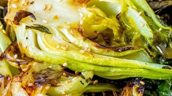 picture of grilled bok choy with sesame seeds on a wooden plate