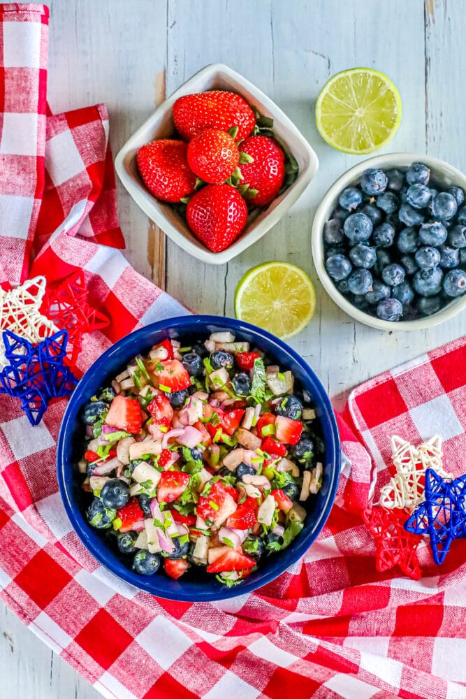 red white and blue fruit salsa in a bowl with cilantro and red onion