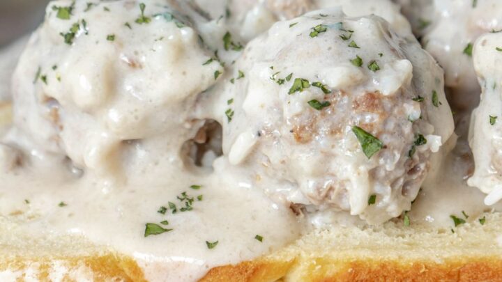 picture of porcupine meatballs on a slice of sourdough bread in a white sauce