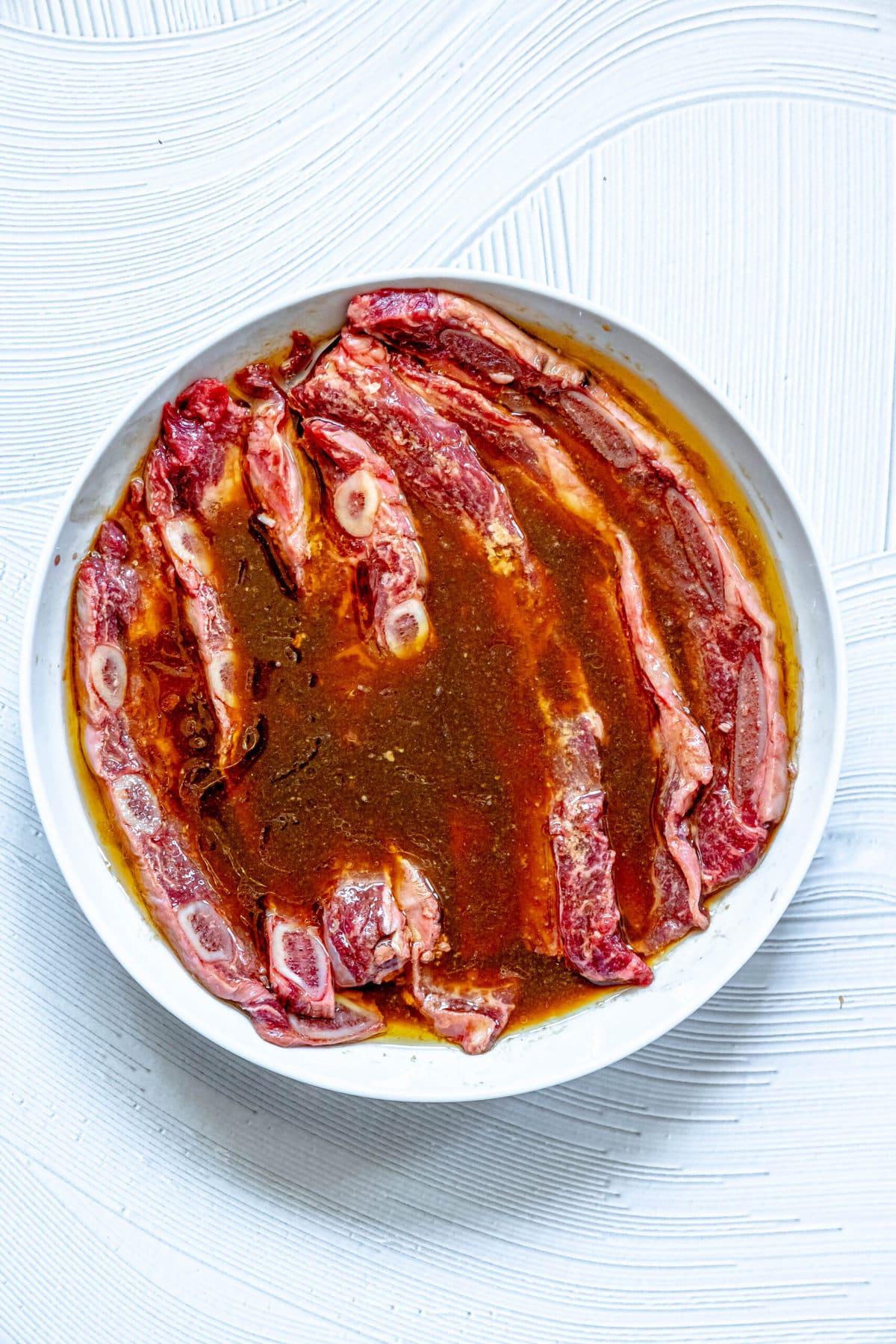 picture of flanken ribs marinating in korean bbq sauce