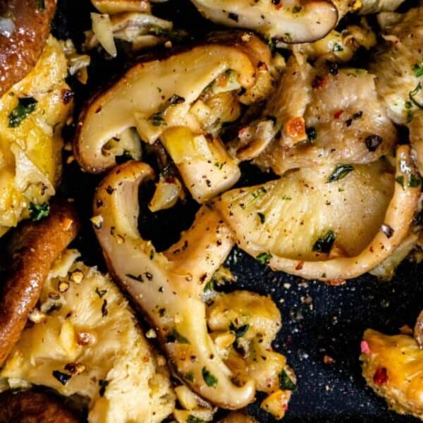 Roasted mushrooms in a pan with herbs.