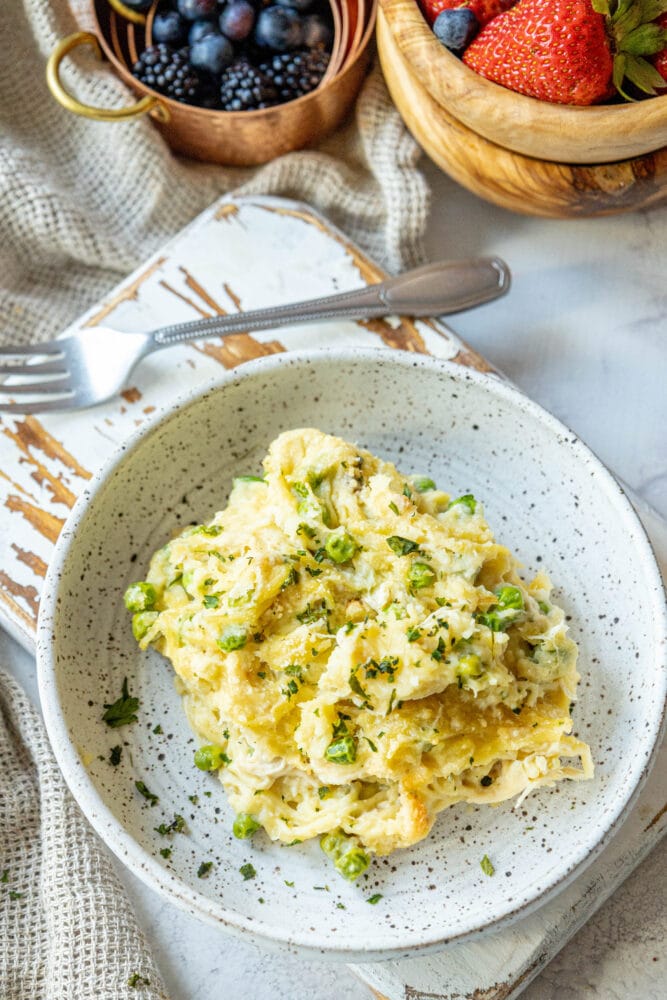 picture of baked chicken tetrazzini noodle casserole with peas on a plate