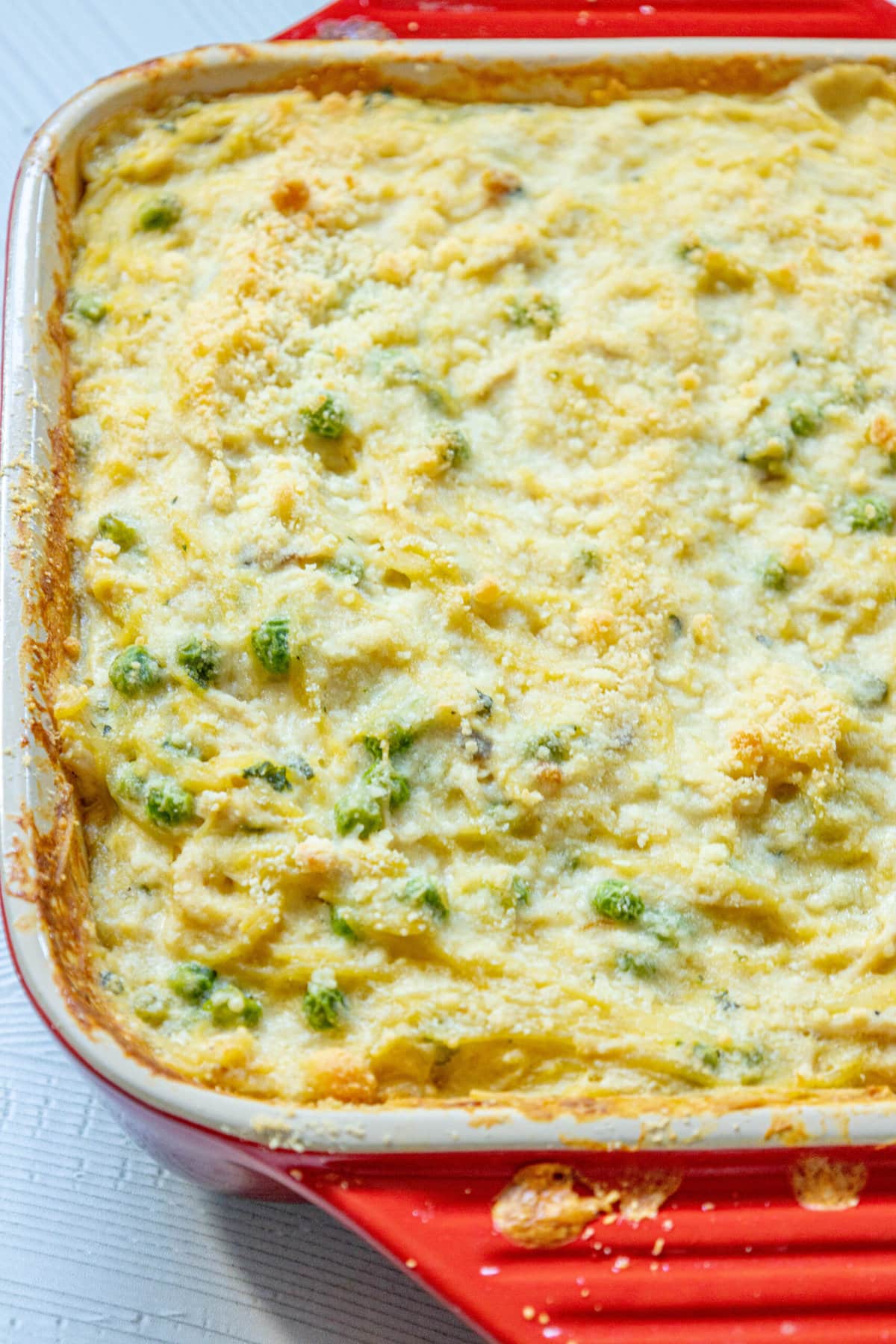 An easy chicken tetrazzini casserole dish with cheese and peas.