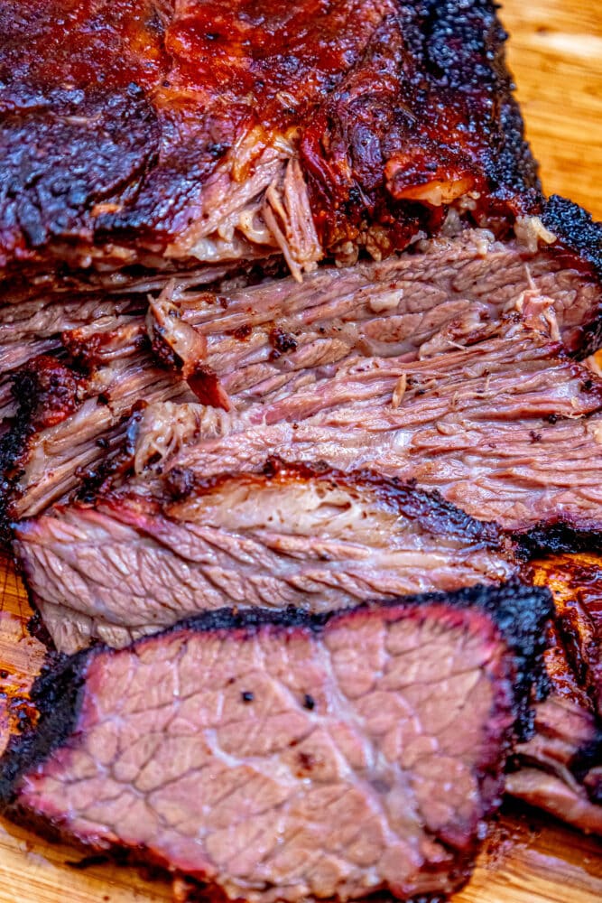 picture of slice smoked brisket on a wooden cutting board