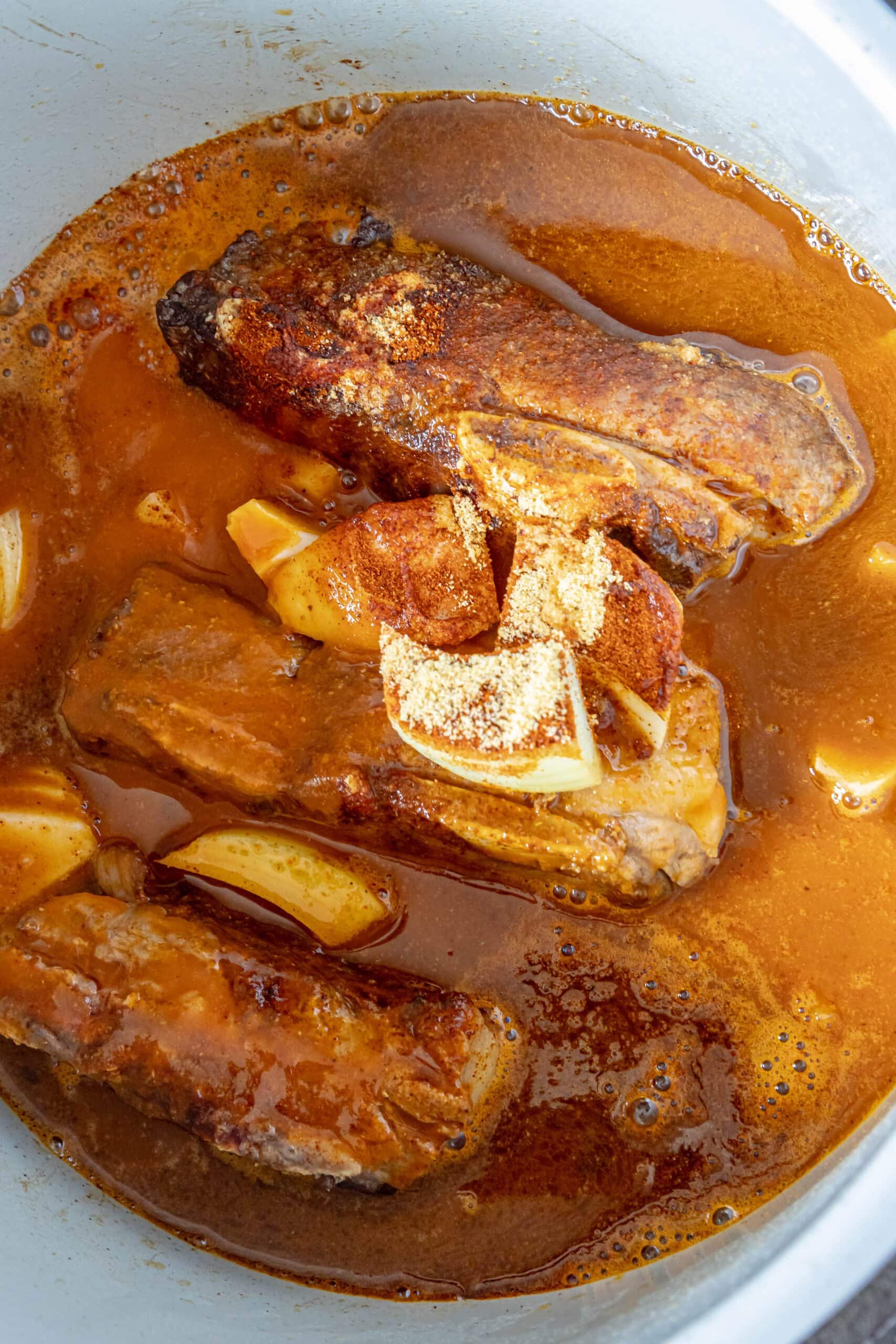 picture of short ribs in an instant pot with spices and beer