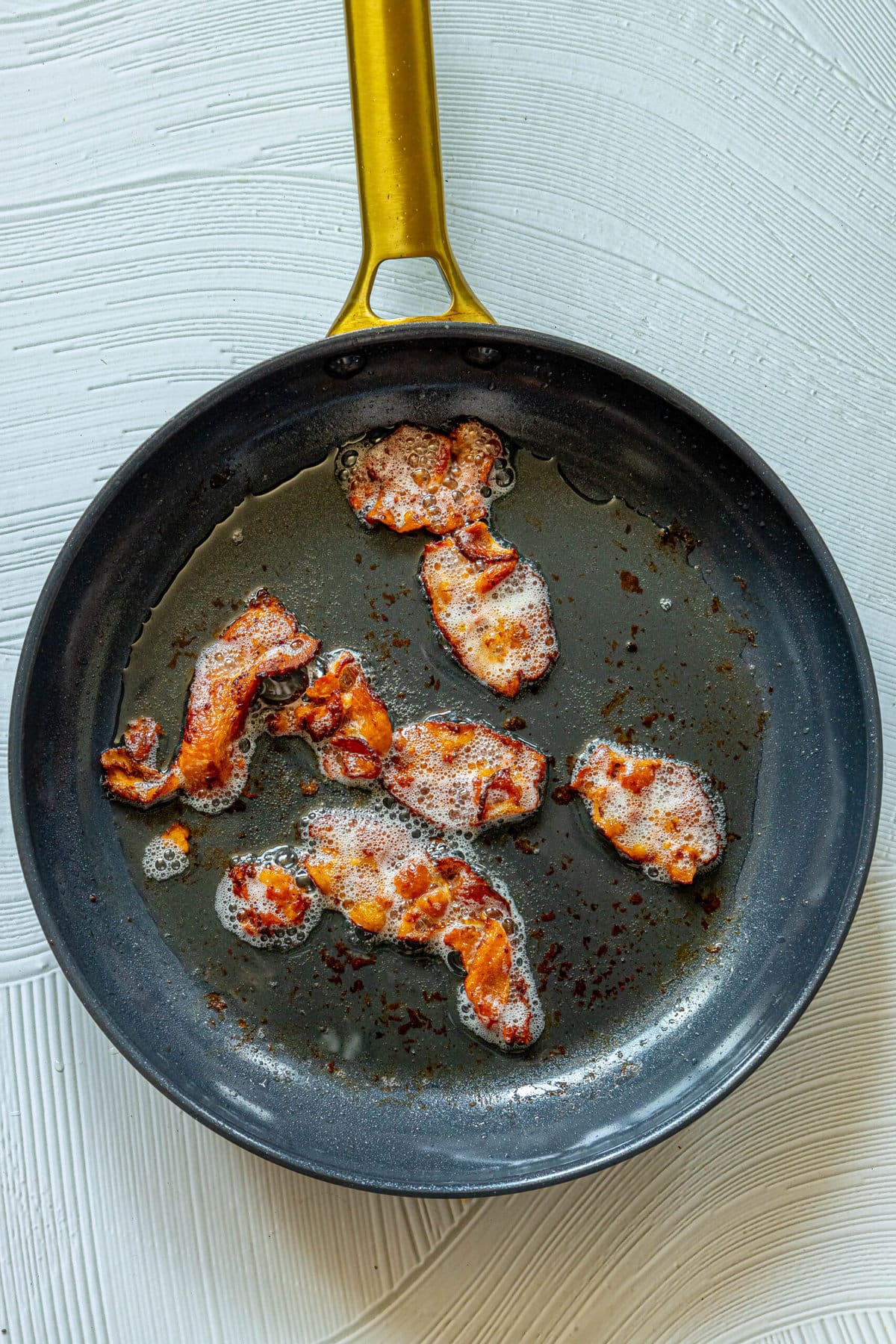 Pan-fried bacon.