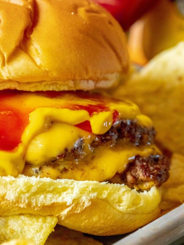 smashburger in a bun with mustard, cheese, and ketchup