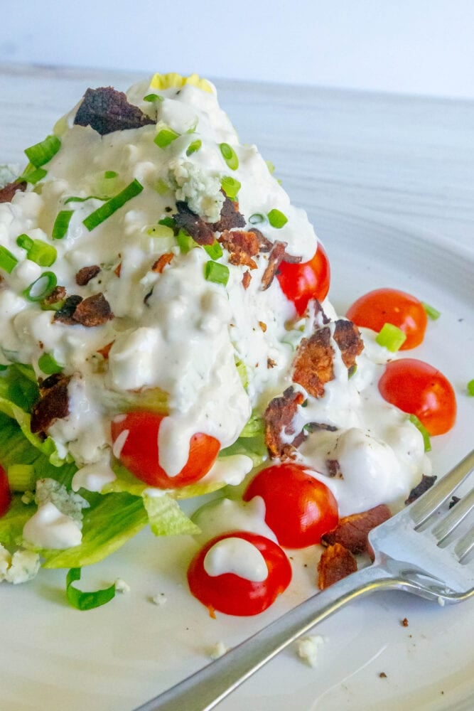 salad with green onions, tomatoes, bacon, and crumbled blue cheese dressing