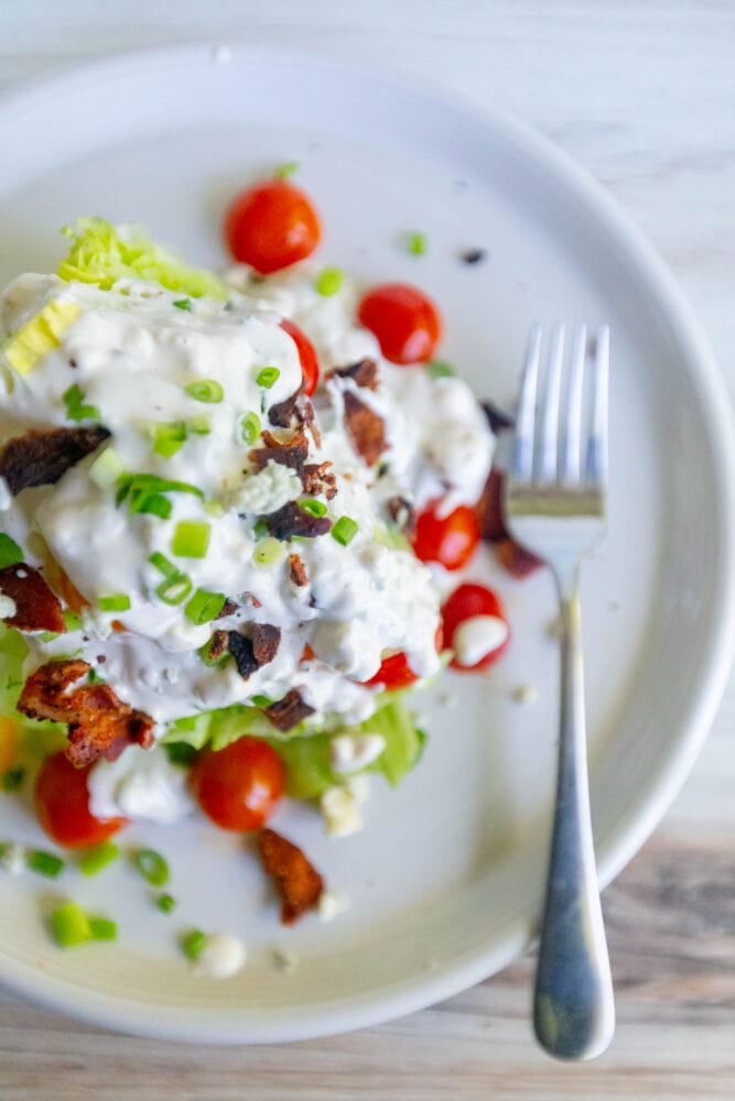 salad with green onions, tomatoes, bacon, and crumbled blue cheese dressing