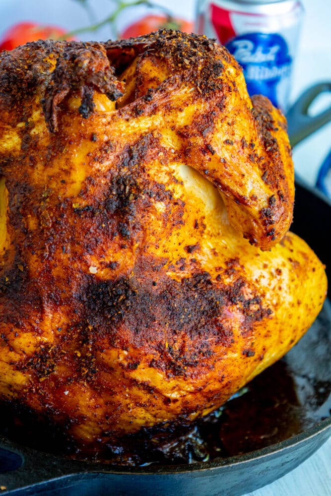 cooked beer can chicken in a cast iron pan 
