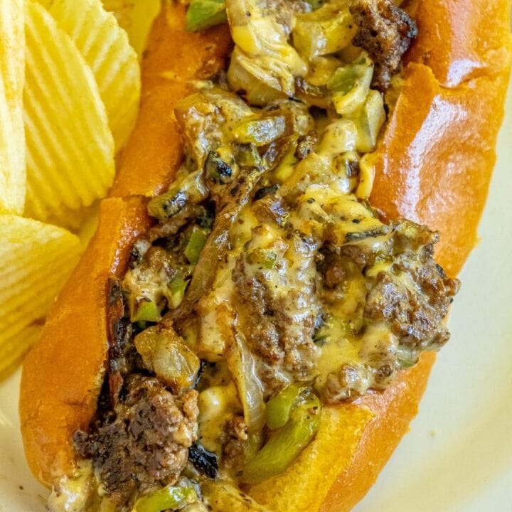 picture of a chopped cheese sandwich on a white plate in a bun