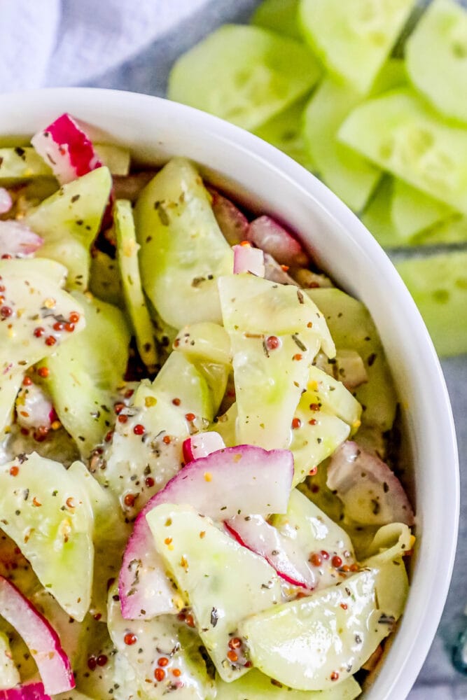 picture of creamy cucumber salad with onion and mustard in a bowl 