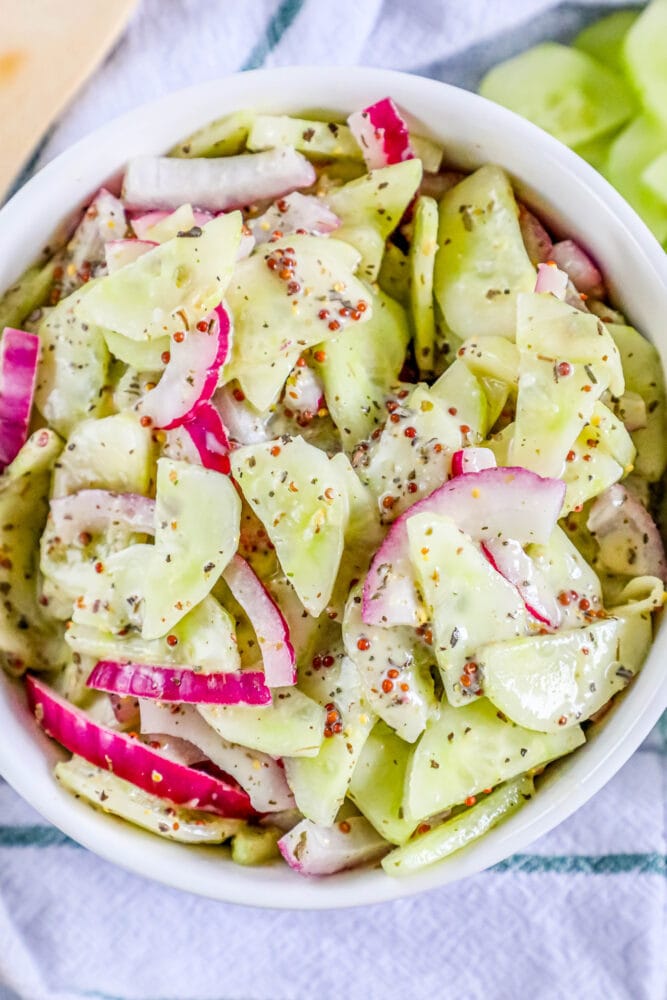 picture of creamy cucumber salad with onion and mustard in a bowl 