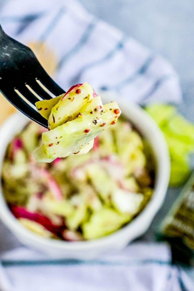 picture of creamy cucumber salad with onion and mustard in a bowl 