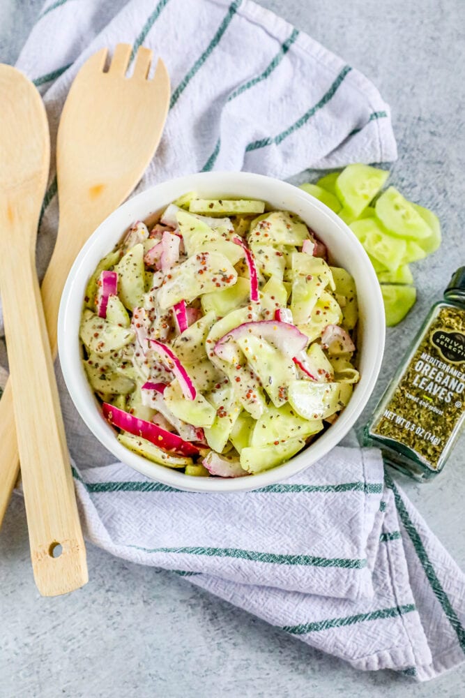 picture of creamy cucumber salad with onion and mustard in a bowl 