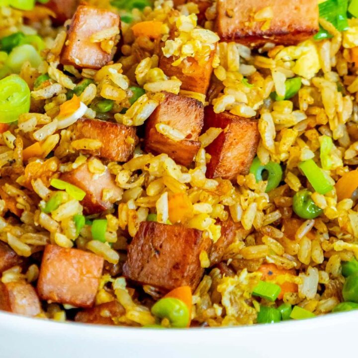 picture of spam fried rice with peppers, peas, and chopped green onions a bowl