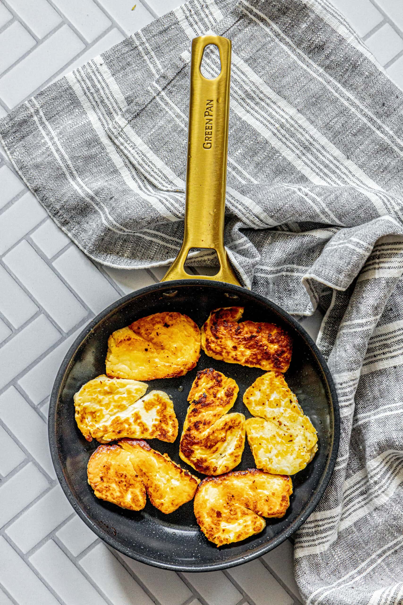 picture of lightly browned fried sliced of halloumi cheese in a pan