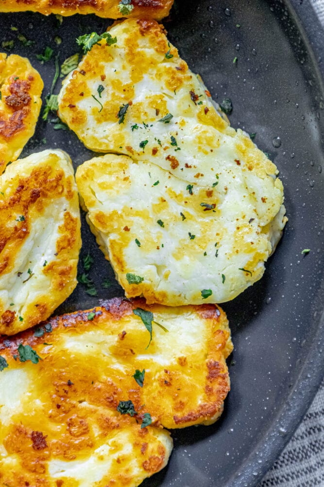 picture of slices of halloumi cheese frying in a pan