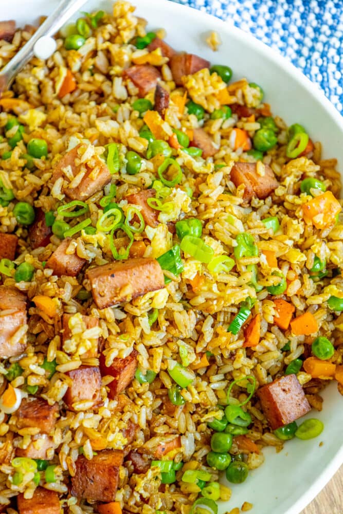 picture of spam fried rice with peppers, peas, and chopped green onions a bowl