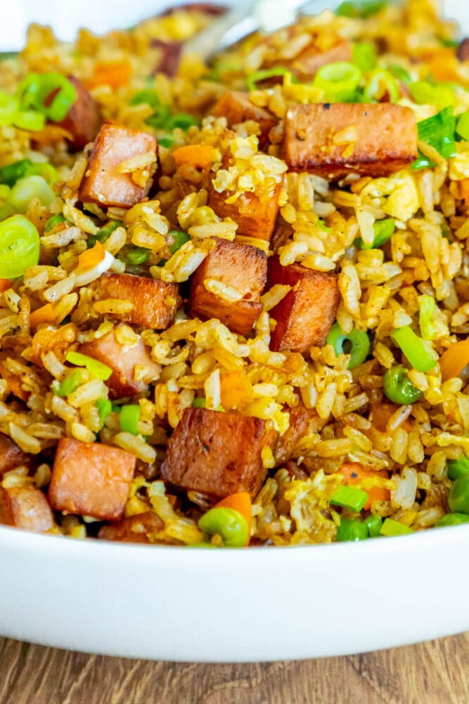 picture of spam fried rice with peppers, peas, and chopped green onions a bowl