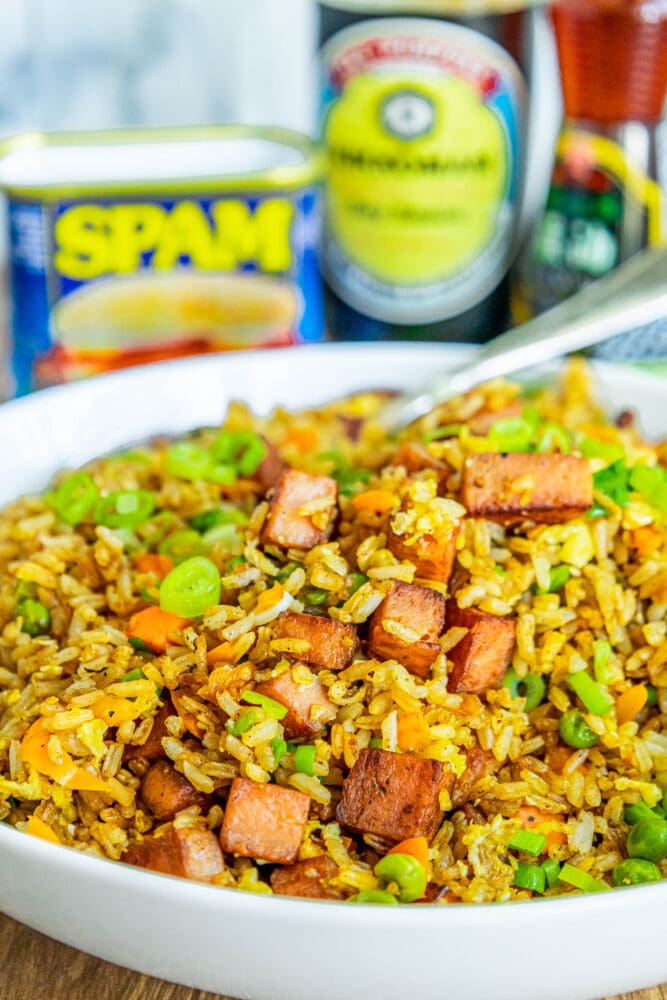 picture of spam fried rice with peppers, peas, and chopped green onions a bowl