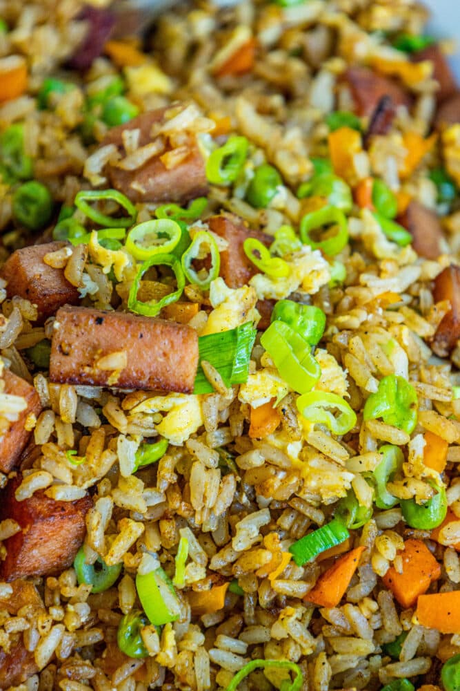 picture of spam fried rice with peppers, peas, and chopped green onions a bowl
