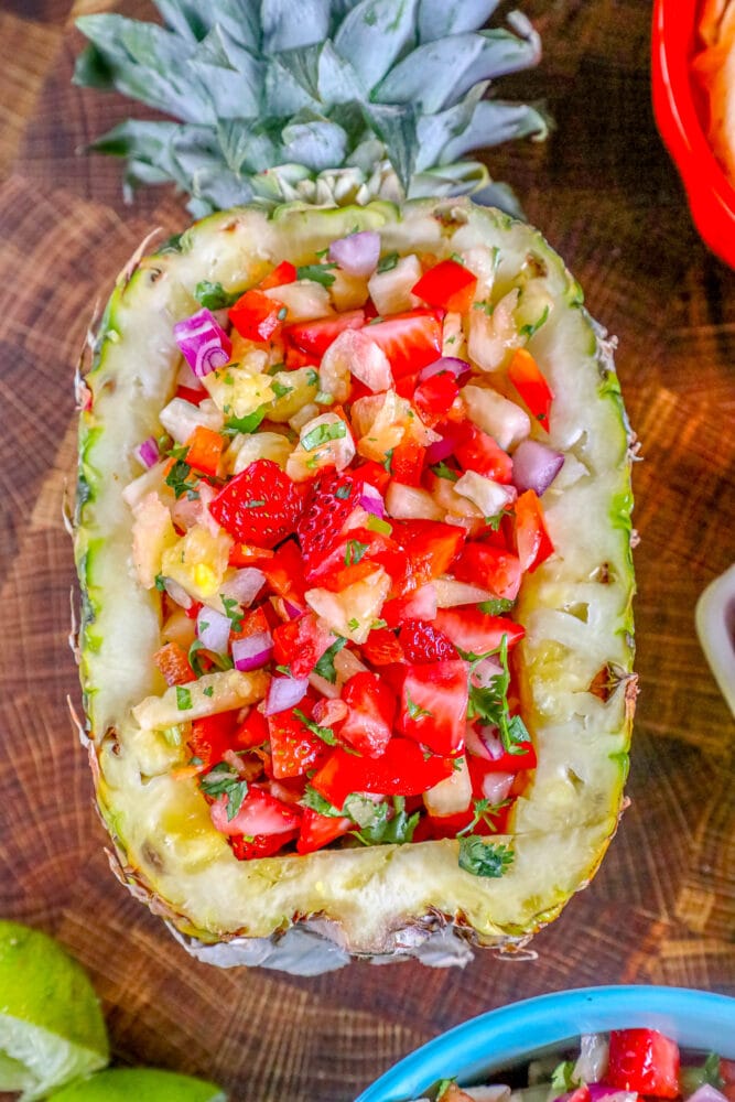 picture of strawberry pineapple salsa in a hollowed out pineapple
