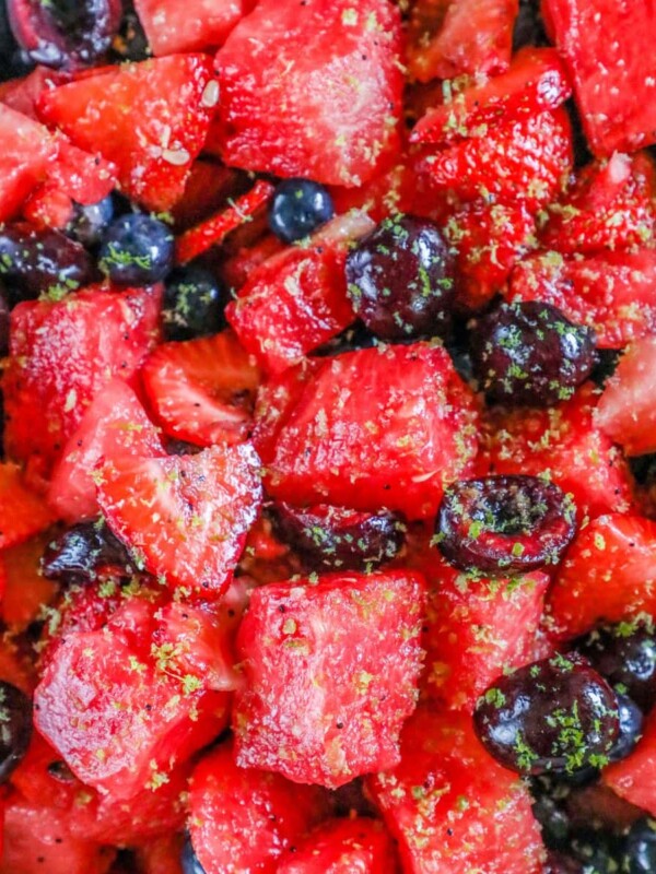 picture of sliced cherries, blueberries, strawberries, and watermelon salad with lime zest and lime honey poppyseed dressing in a bowl