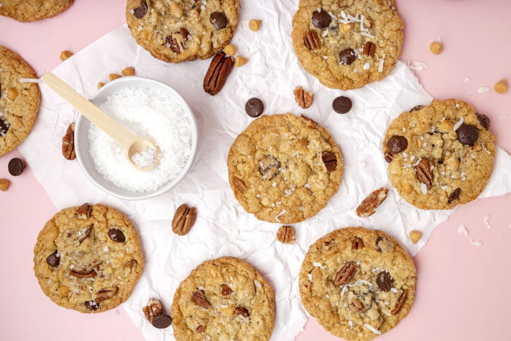 picture of a chocolate chip and oatmeal cookie with butterscotch chips, pecans, coconuts, and salt on top