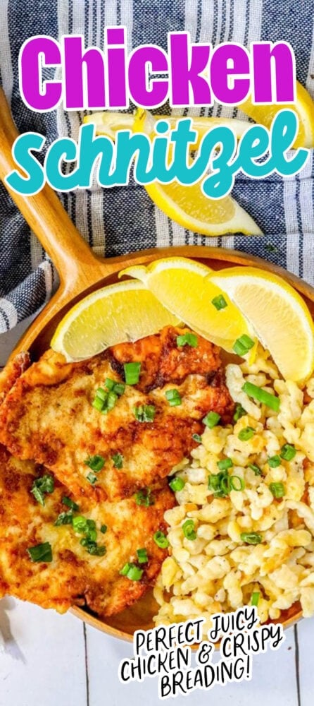 picture of breaded chicken schnitzel in a wooden bowl with green onions on top and lemon slices and spaetzle next to it