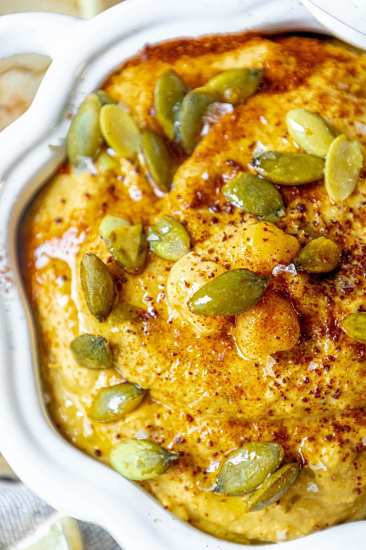 picture of pumpkin hummus in a glass pumpkin bowl
