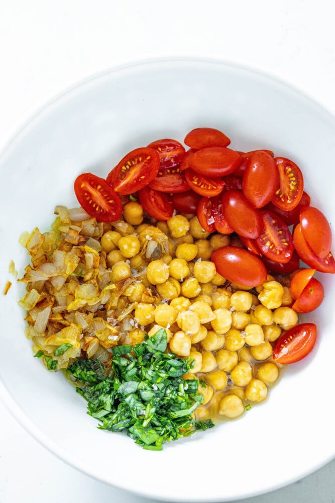 picture of caramelized onions, chickpeas, tomatoes, and herbs in a bowl 