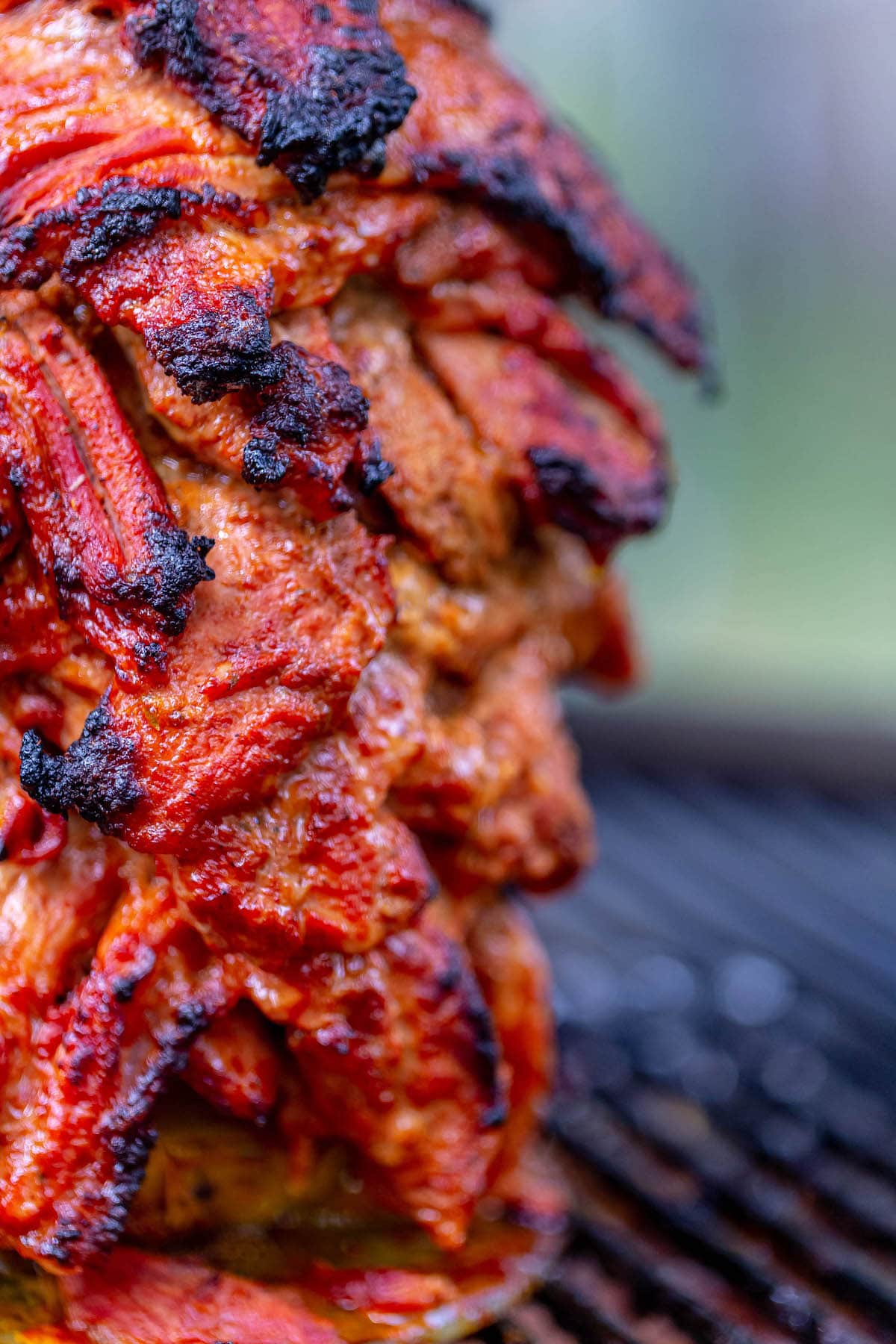 picture of al pastor on a spit on a grill 