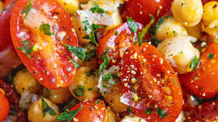 picture of tomatoes, chickpeas, shallots and herbs mixed in a bowl