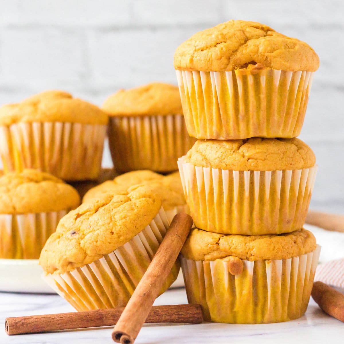 picture of pumpkin spice muffins stacked on a table