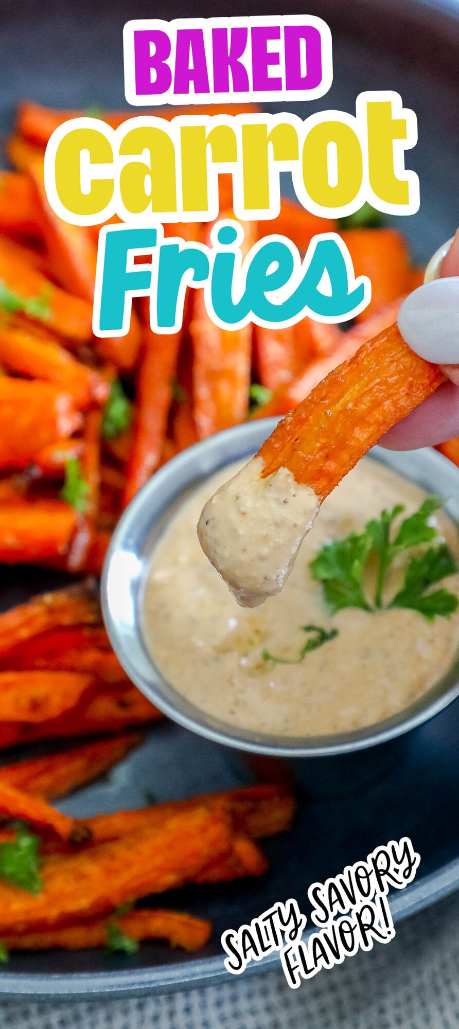 picture of a hand holding a carrot fry dipped in sauce 