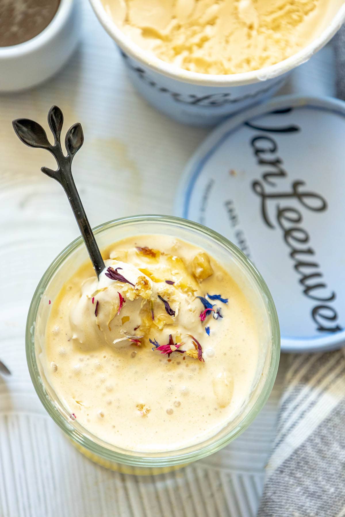 picture of earl grey affogato in a glass mug with corn flowers on top