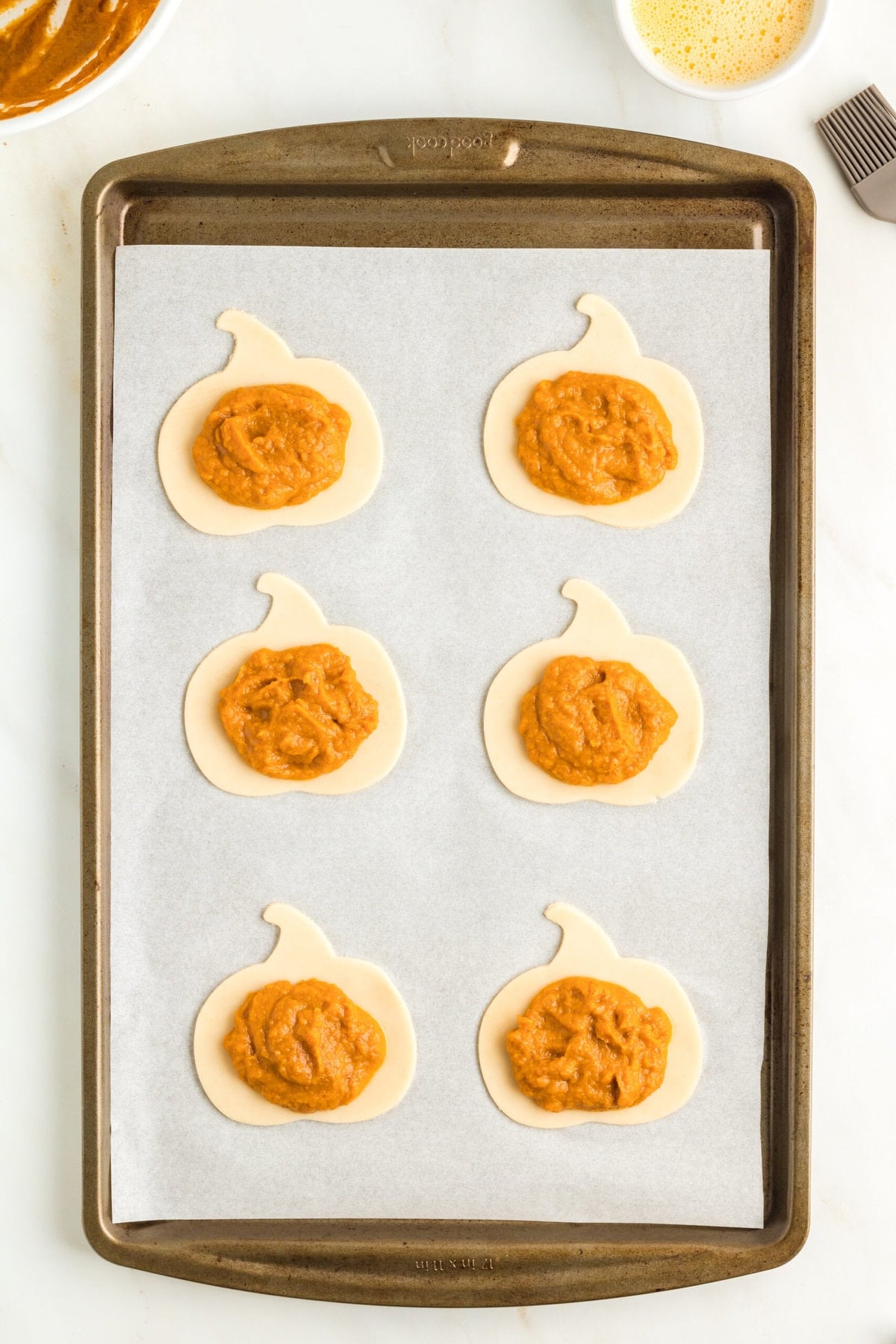 picture of pumpkin pie filling spooned onto pumpkin shaped dough