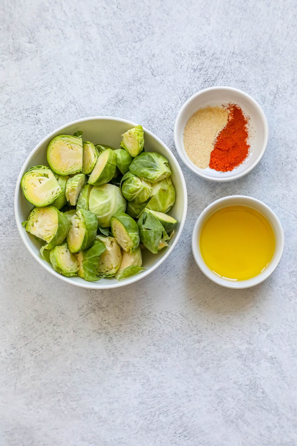 picture of brussels sprouts, oil, and seasonings on a table