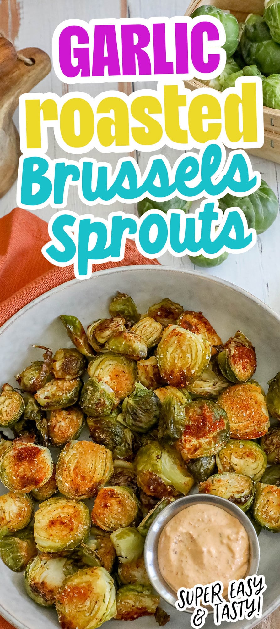 picture of garlic roasted brussels sprouts in a white bowl with a cup of sauce