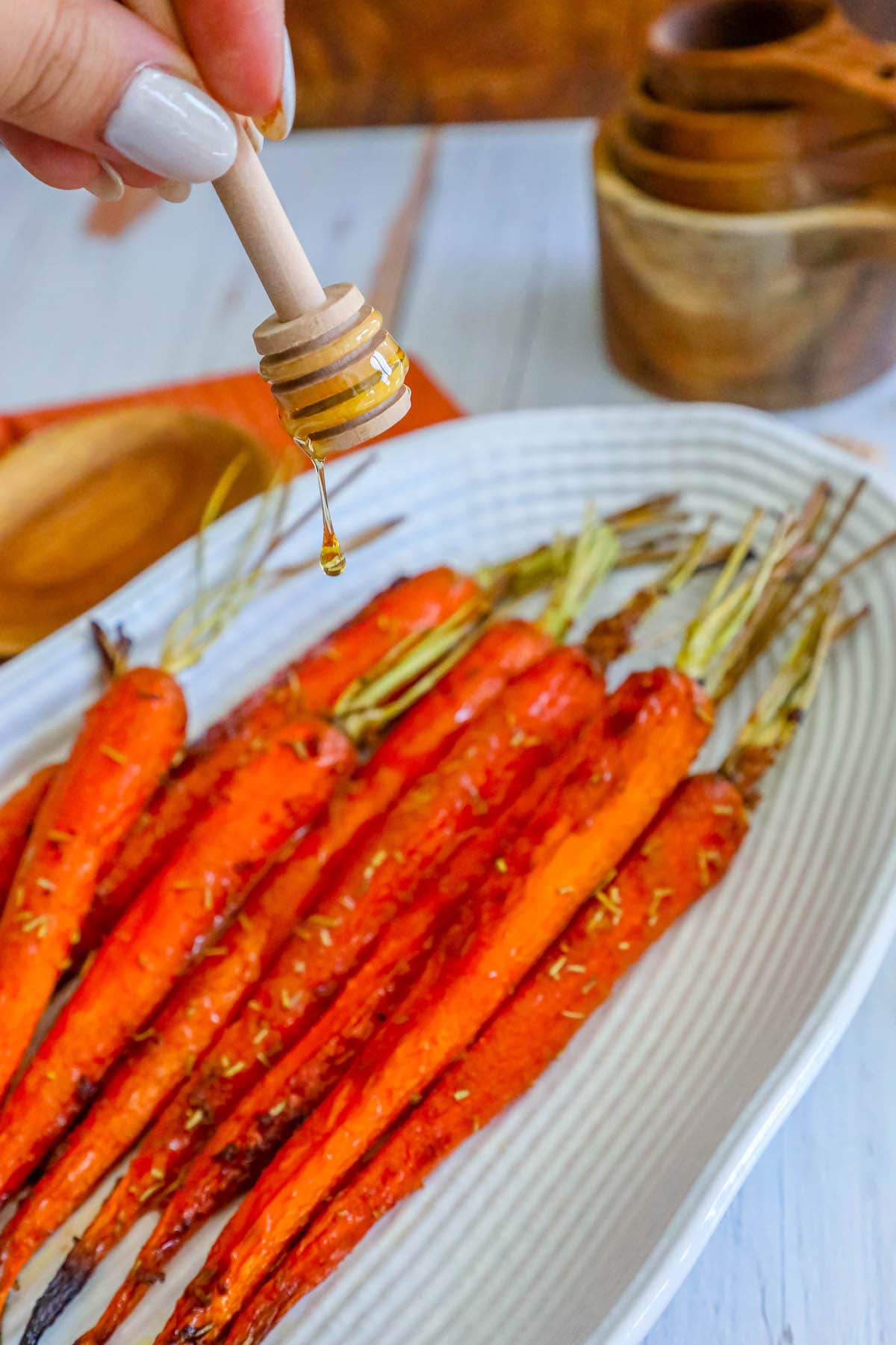 picture of honey garlic carrots on a plate with herbs