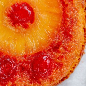 picture of pineapple upside down cake with a pineapple and maraschino cherry baked onto the top