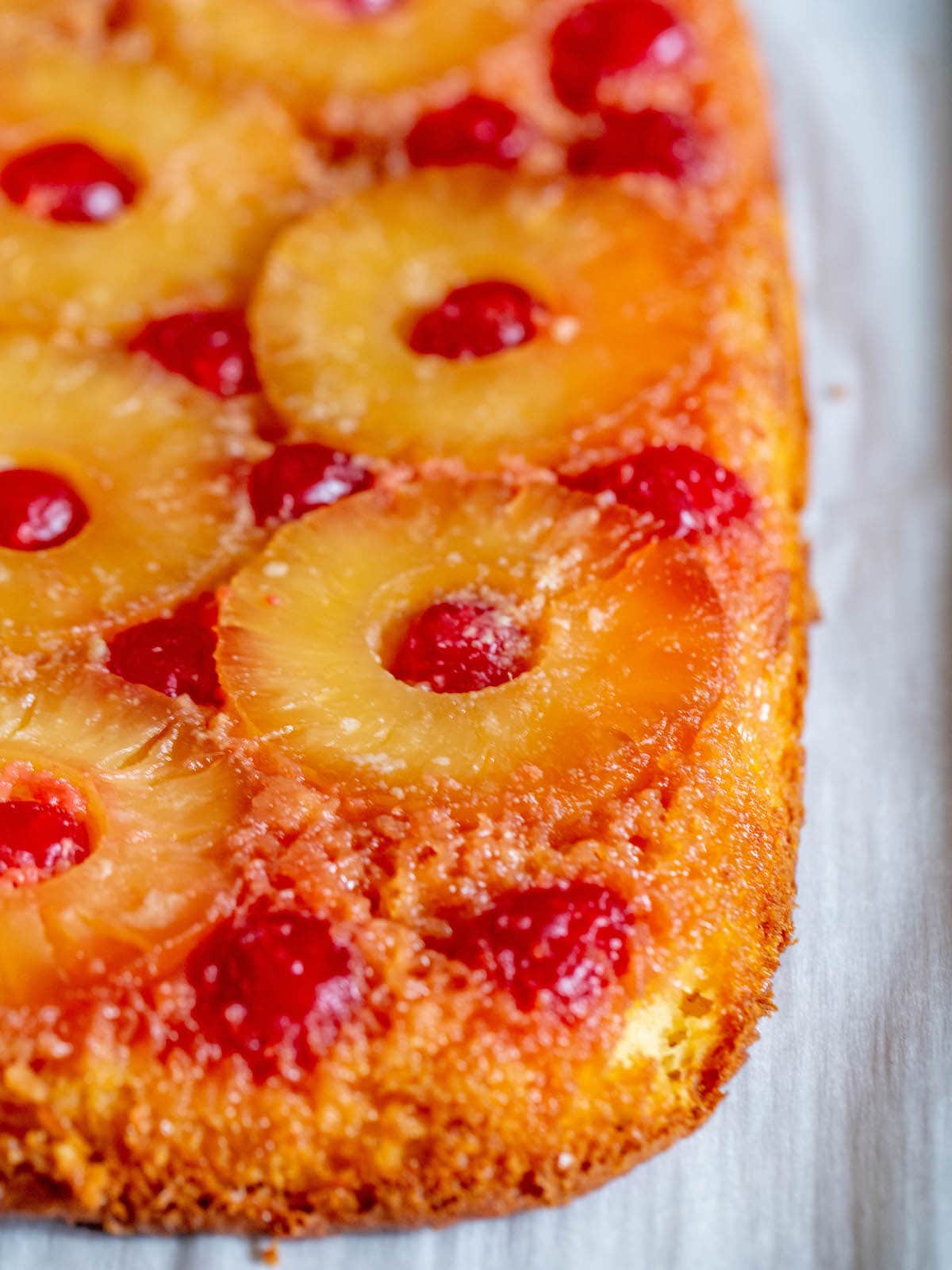 picture of pineapple upside down cake with a pineapples and maraschino cherries baked onto the top