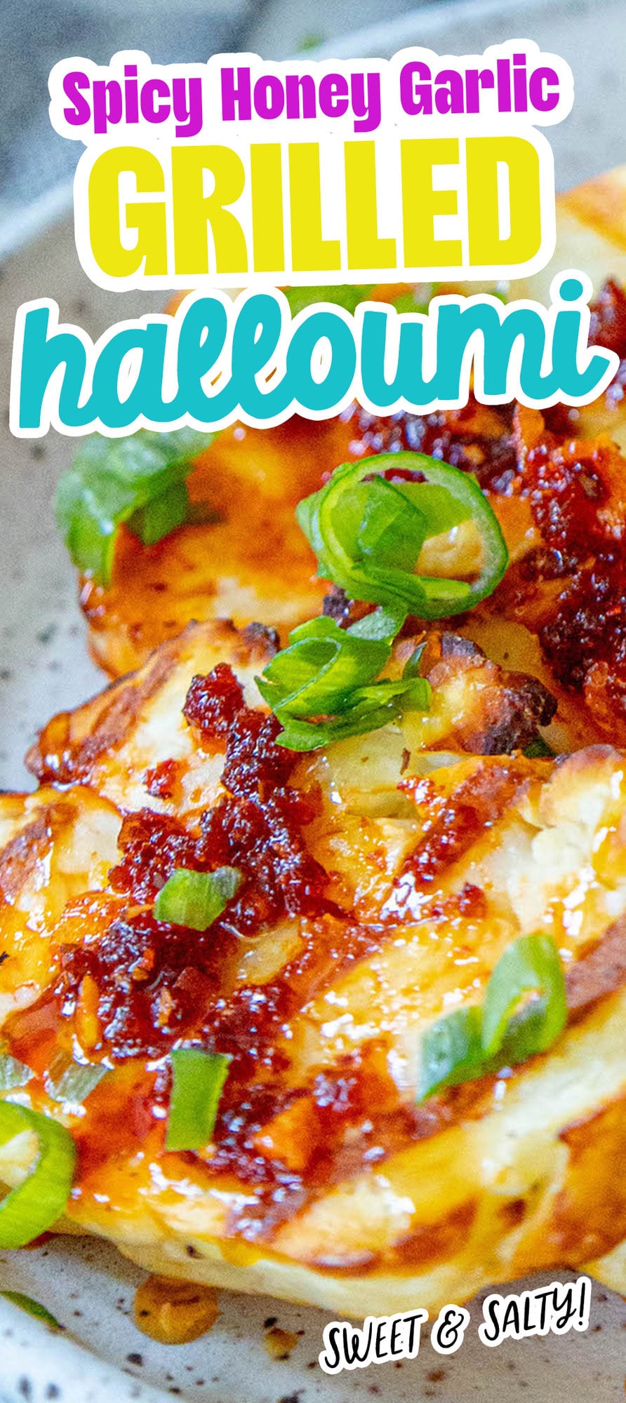 picture of grilled halloumi on a plate topped with spicy garlic, scallions, and honey