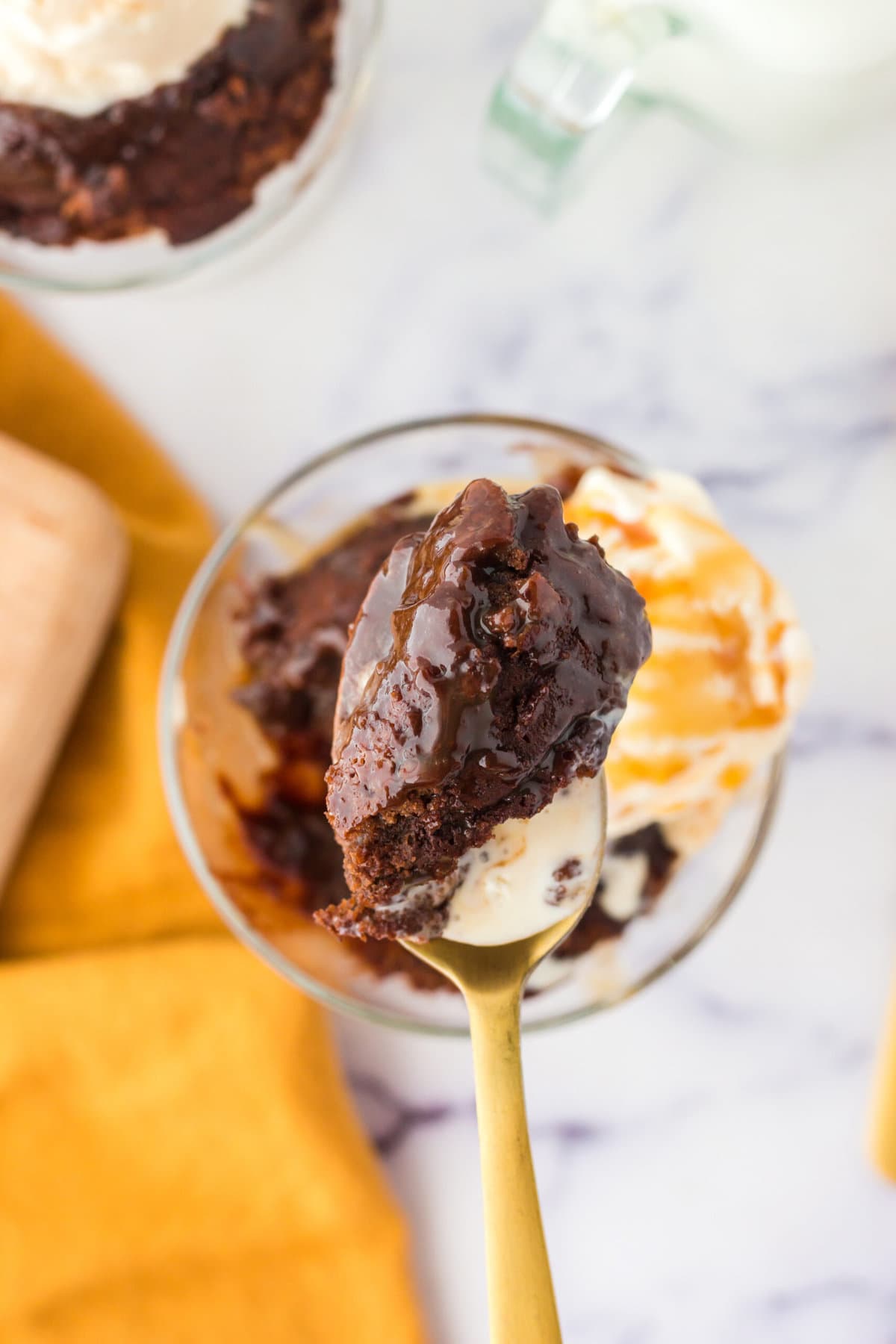 picture of caramel lava cake on a spoon with ice cream